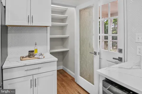 a kitchen with a sink a stove and cabinets