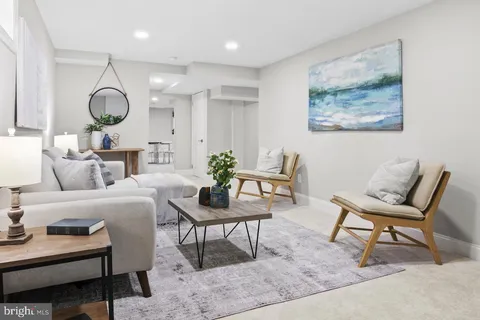 a living room with furniture and a mirror
