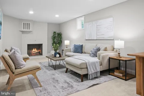 a bedroom with furniture and a fireplace