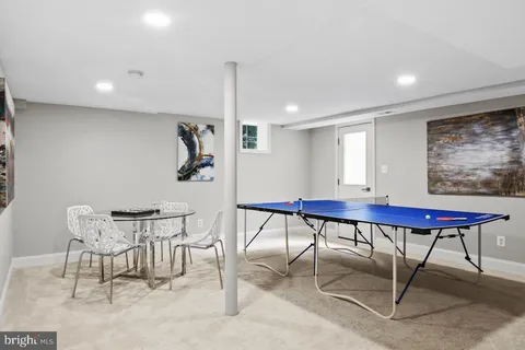 a room with furniture pool table and a rug