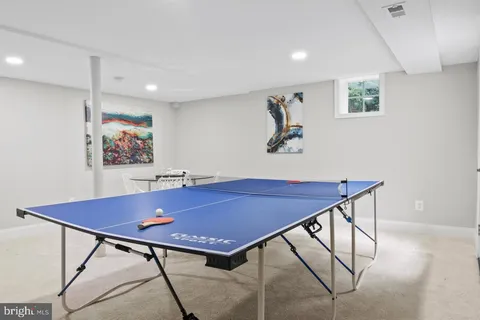 a view of a room with a table and chairs