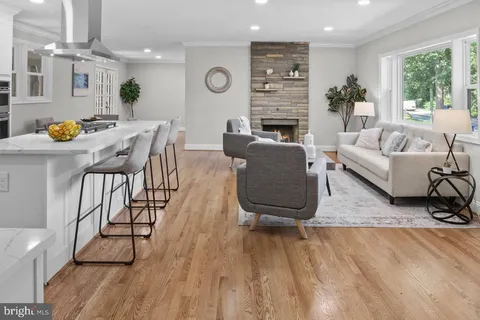 a living room with furniture wooden floor and window