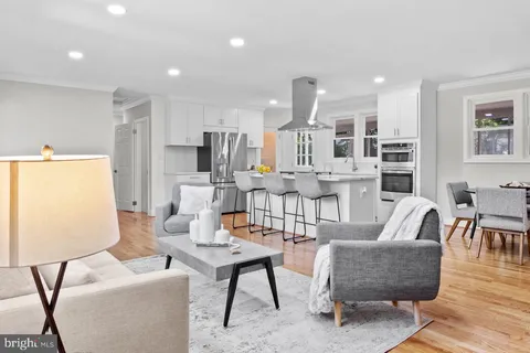 a living room with fireplace furniture and a wooden floor
