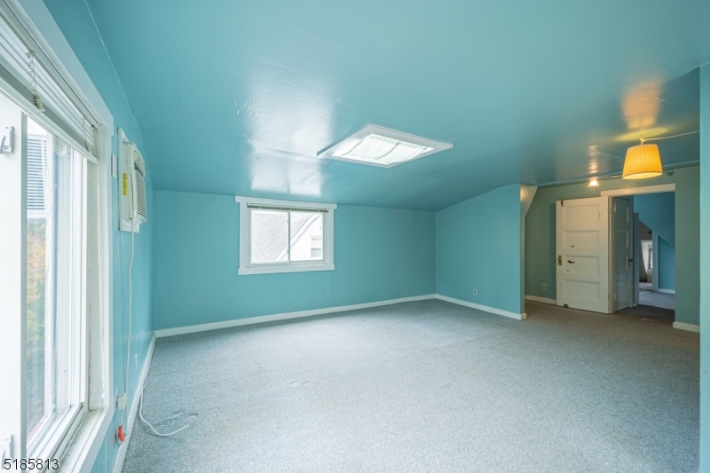 180 Bellevue Avenue Montclair, NJ 07043 - Photo 6 of 13 a view of an empty room with a window and a kitchen