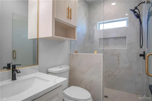 a white toilet sitting next to a bathroom sink