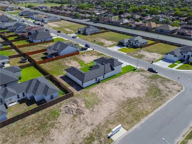swimming pool with outdoor seating and trees in the background