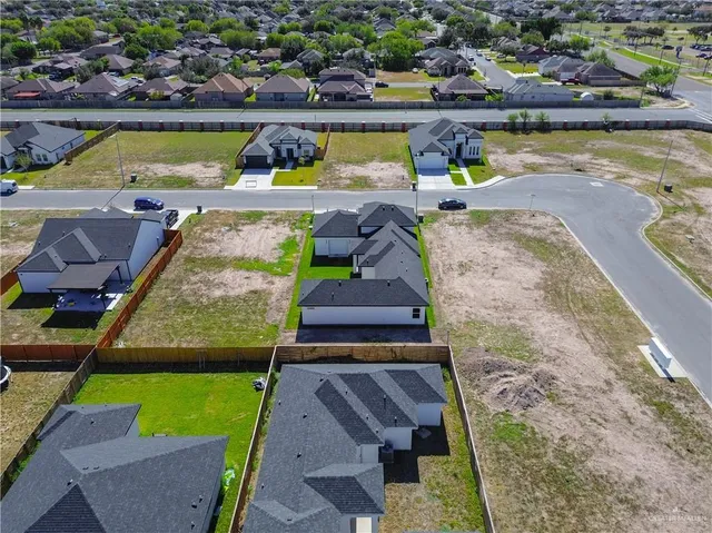 a view of a swimming pool with a lawn chairs under an umbrella