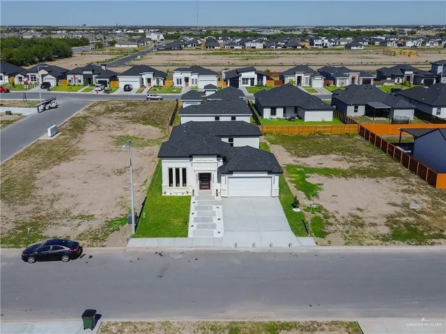 an aerial view of a house with a garden and patio