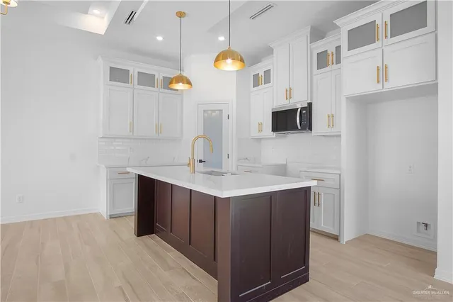 a kitchen with a sink and a refrigerator