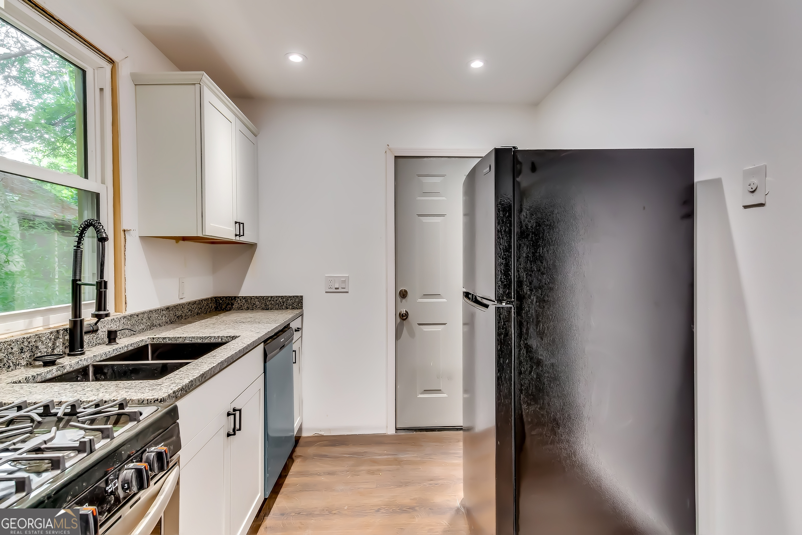 1126 Briarcliff Place Northeast, Unit 2 Atlanta, GA 30306 - Photo 4 of 12 a kitchen with a refrigerator and a stove top oven