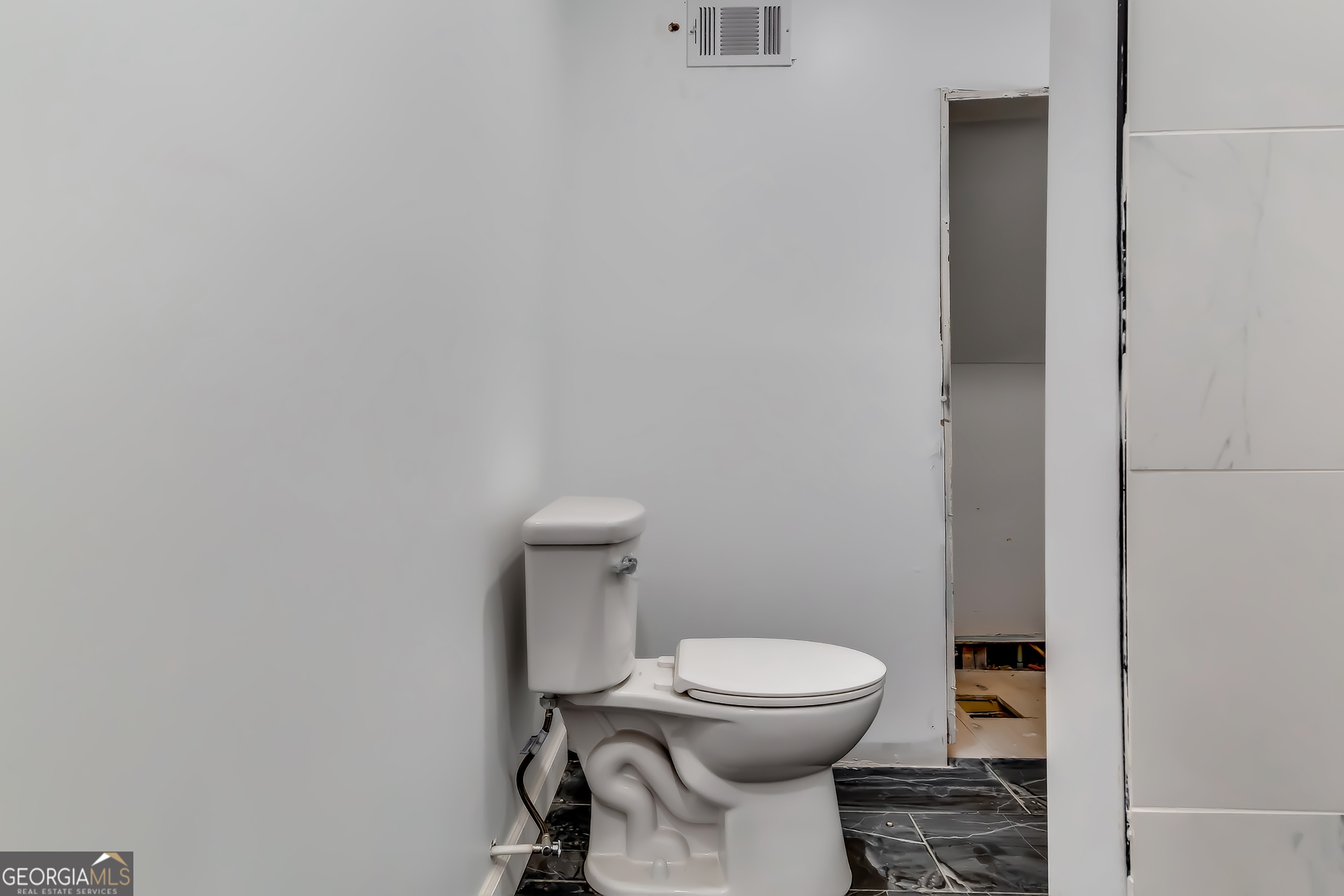 1126 Briarcliff Place Northeast, Unit 2 Atlanta, GA 30306 - Photo 6 of 12 a white toilet sitting next to a white cabinet