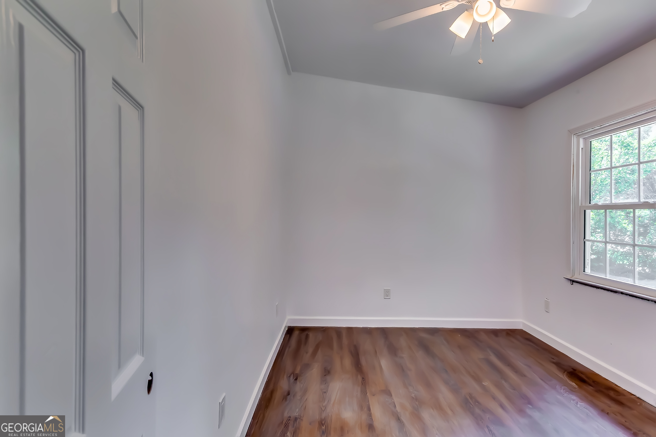 1126 Briarcliff Place Northeast, Unit 2 Atlanta, GA 30306 - Photo 8 of 12 a view of an empty room with wooden floor and a window