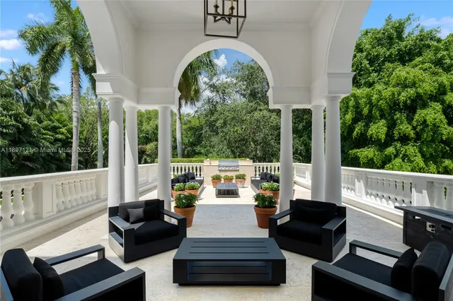 a view of a patio with couches table and chairs and potted plants