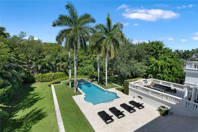 a view of a backyard with plants and a patio