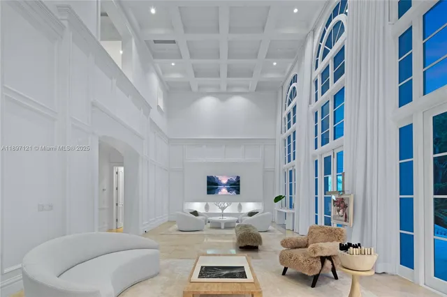 a living room with furniture and a book shelf