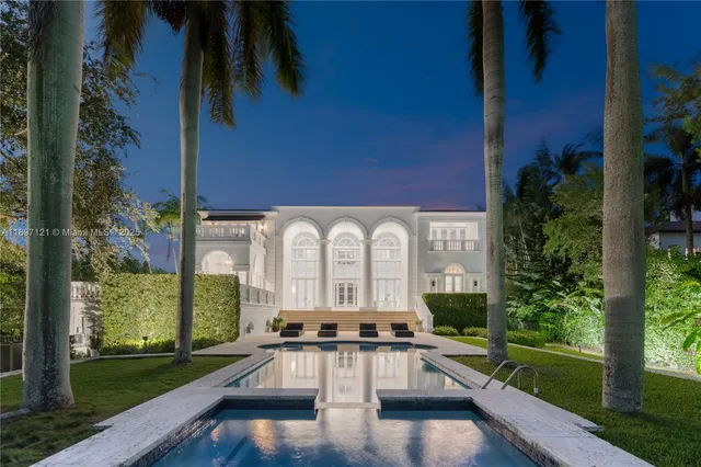 a view of a house with swimming pool and sitting area