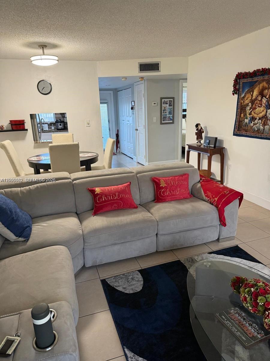 2900 North Pine Island Road, Unit 209 Sunrise, FL 33322 - Photo 4 of 14 a living room with furniture and a couch