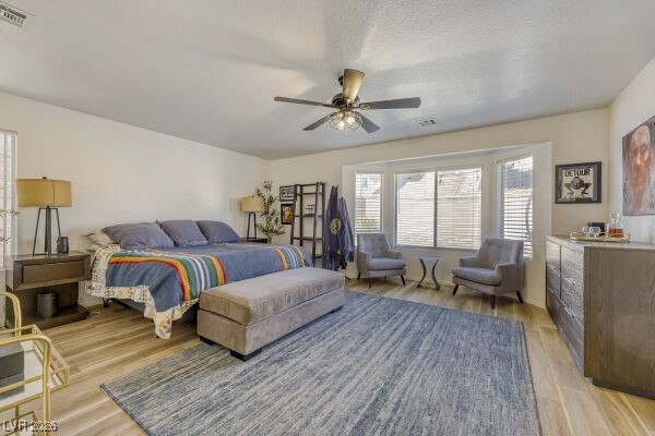 1536 Pony Ranch Circle Henderson, NV 89014 - Photo 13 of 24 Bedroom with ceiling fan and light wood-type flooring