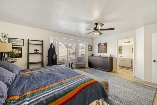 1536 Pony Ranch Circle Henderson, NV 89014 - Photo 15 of 24 Bedroom with wood finished floors, a ceiling fan, and ensuite bath