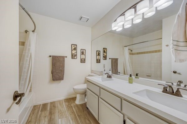 1536 Pony Ranch Circle Henderson, NV 89014 - Photo 18 of 24 Full bathroom featuring shower / bathtub combination with curtain, double vanity, and light wood finished floors