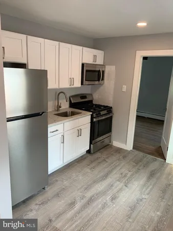 a kitchen with stainless steel appliances a refrigerator stove microwave and sink