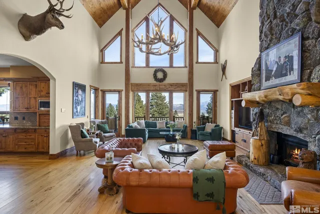 a living room with furniture fireplace and a large window