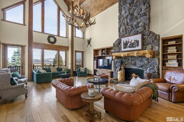 a living room with furniture a chandelier and a fireplace