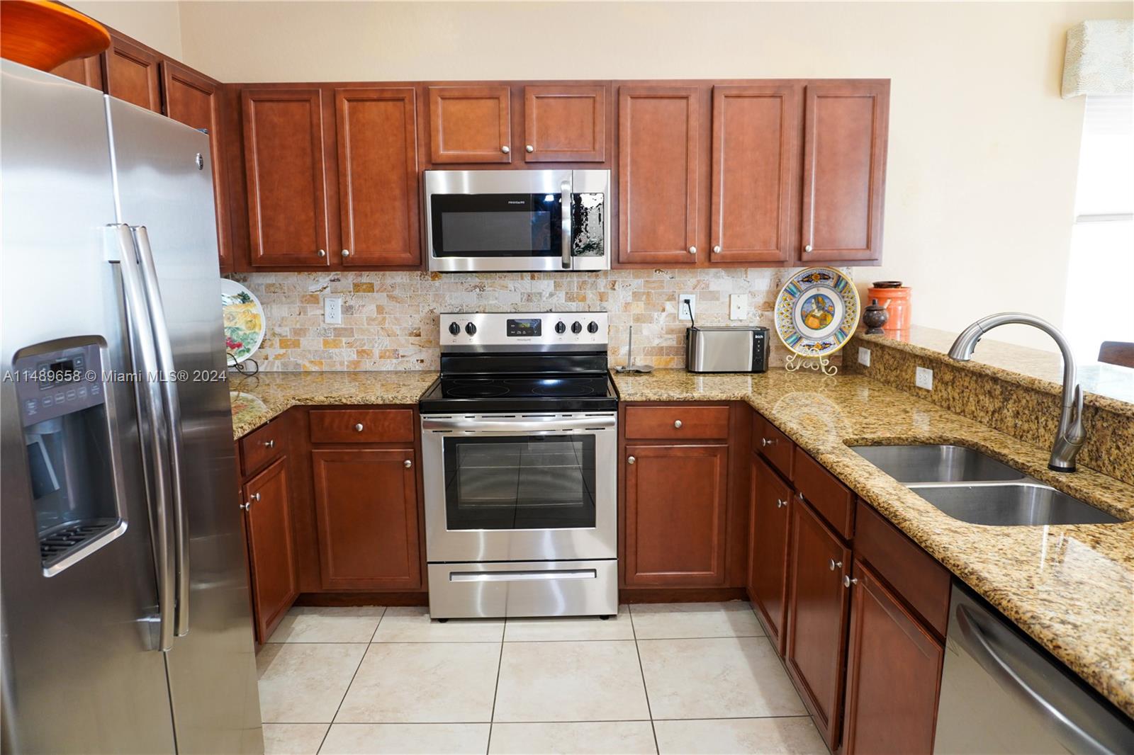 3522 West 88th Street Hialeah, FL 33018 - Photo 14 of 52 a kitchen with stainless steel appliances granite countertop a refrigerator stove and sink