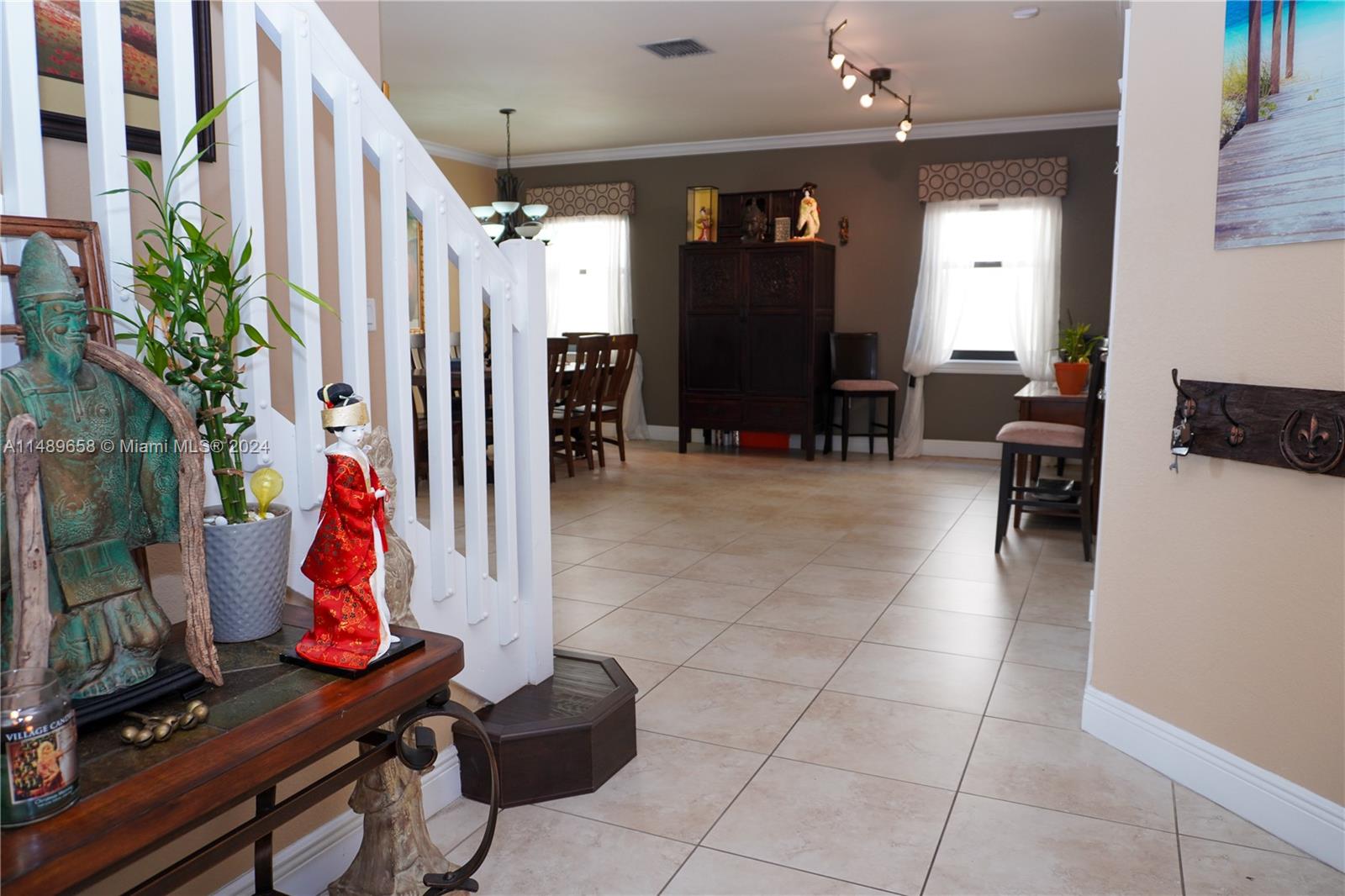 3522 West 88th Street Hialeah, FL 33018 - Photo 17 of 52 a dining room with furniture and a flat screen tv