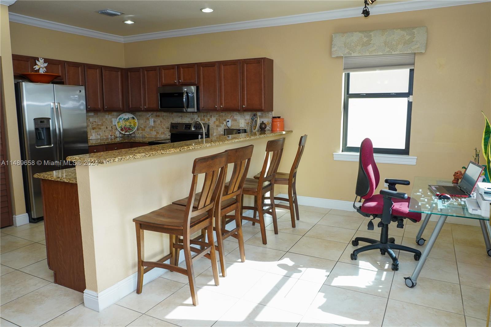 3522 West 88th Street Hialeah, FL 33018 - Photo 18 of 52 a kitchen with stainless steel appliances kitchen island granite countertop a refrigerator and a stove top oven
