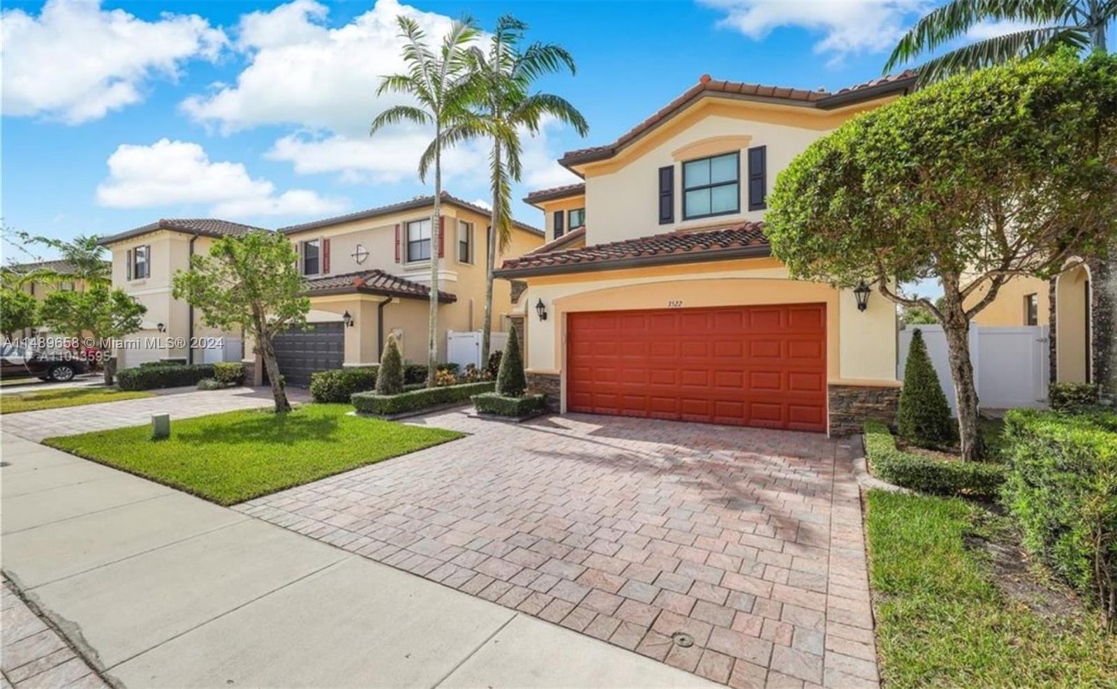 3522 West 88th Street Hialeah, FL 33018 - Photo 2 of 52 a front view of a house with a yard and garage