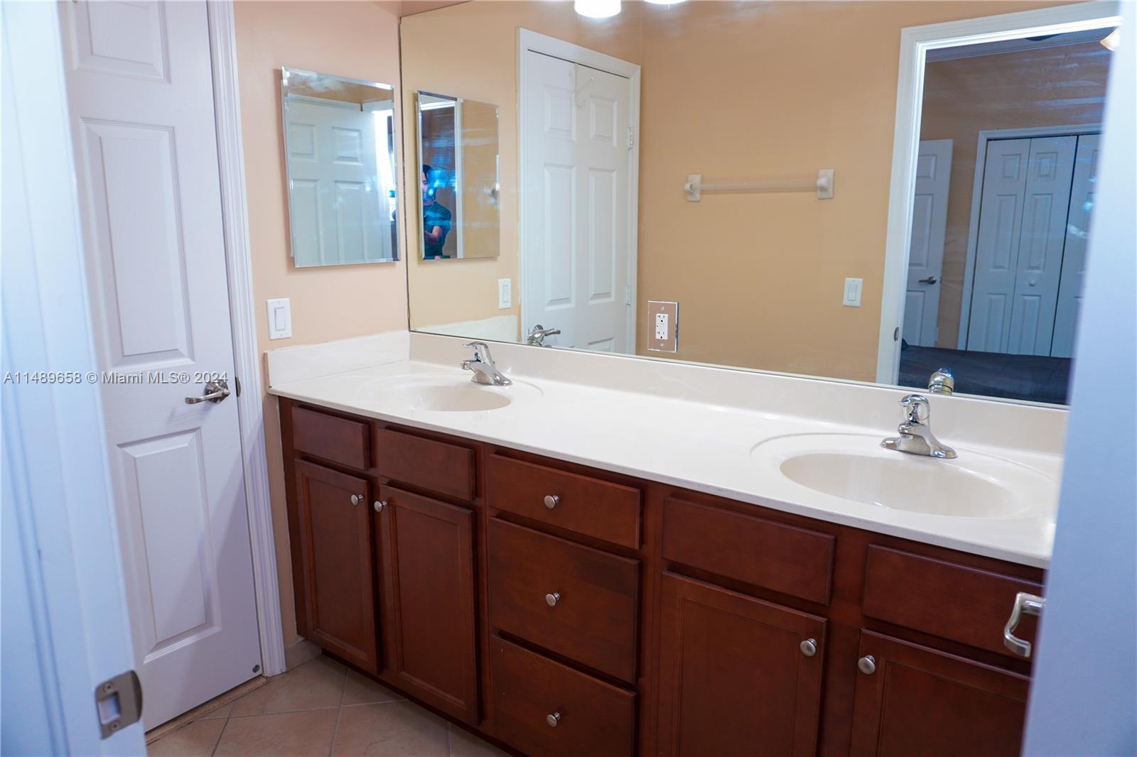 3522 West 88th Street Hialeah, FL 33018 - Photo 23 of 52 a bathroom with a double vanity sink and mirror