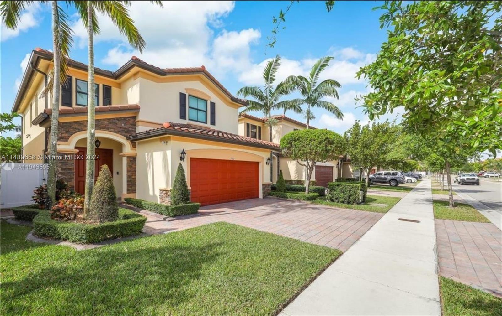 3522 West 88th Street Hialeah, FL 33018 - Photo 3 of 52 a front view of a house with a yard and trees