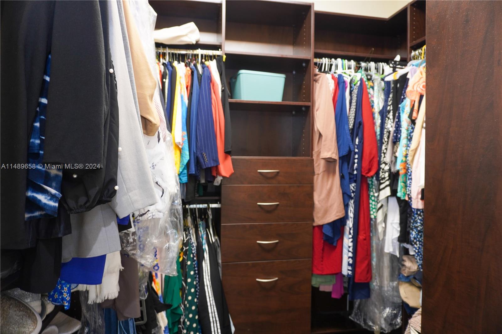 3522 West 88th Street Hialeah, FL 33018 - Photo 32 of 52 a view of walk in closet with clothes