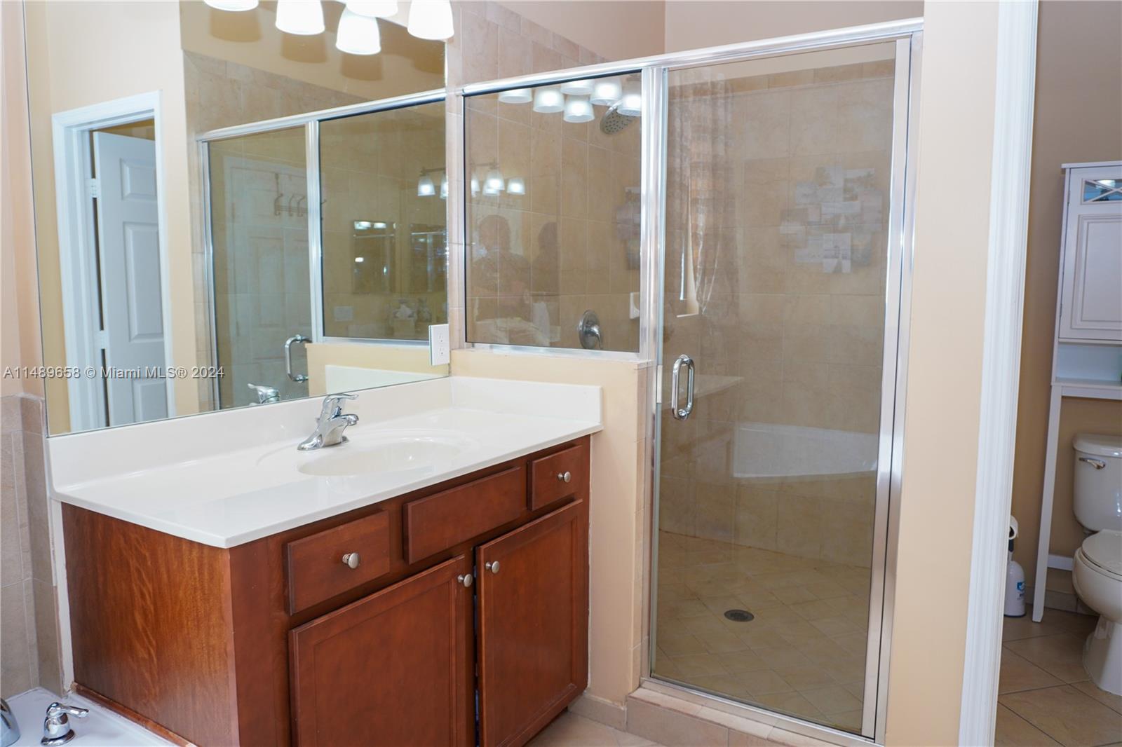 3522 West 88th Street Hialeah, FL 33018 - Photo 35 of 52 a bathroom with a sink and a mirror