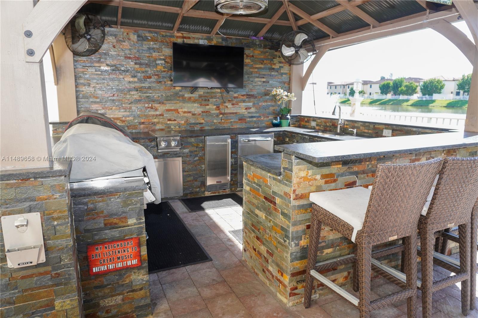 3522 West 88th Street Hialeah, FL 33018 - Photo 40 of 52 a terrace with a table and chairs