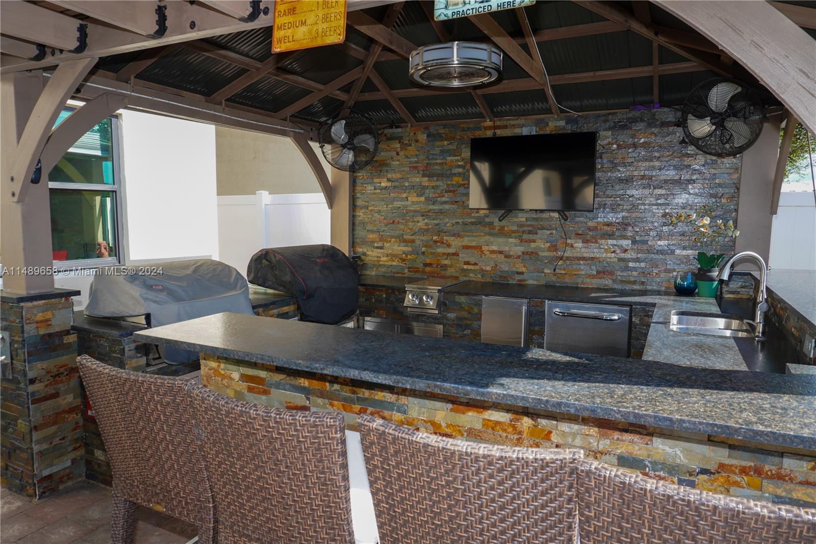 3522 West 88th Street Hialeah, FL 33018 - Photo 41 of 52 a kitchen with stainless steel appliances granite countertop a sink and a granite counter tops