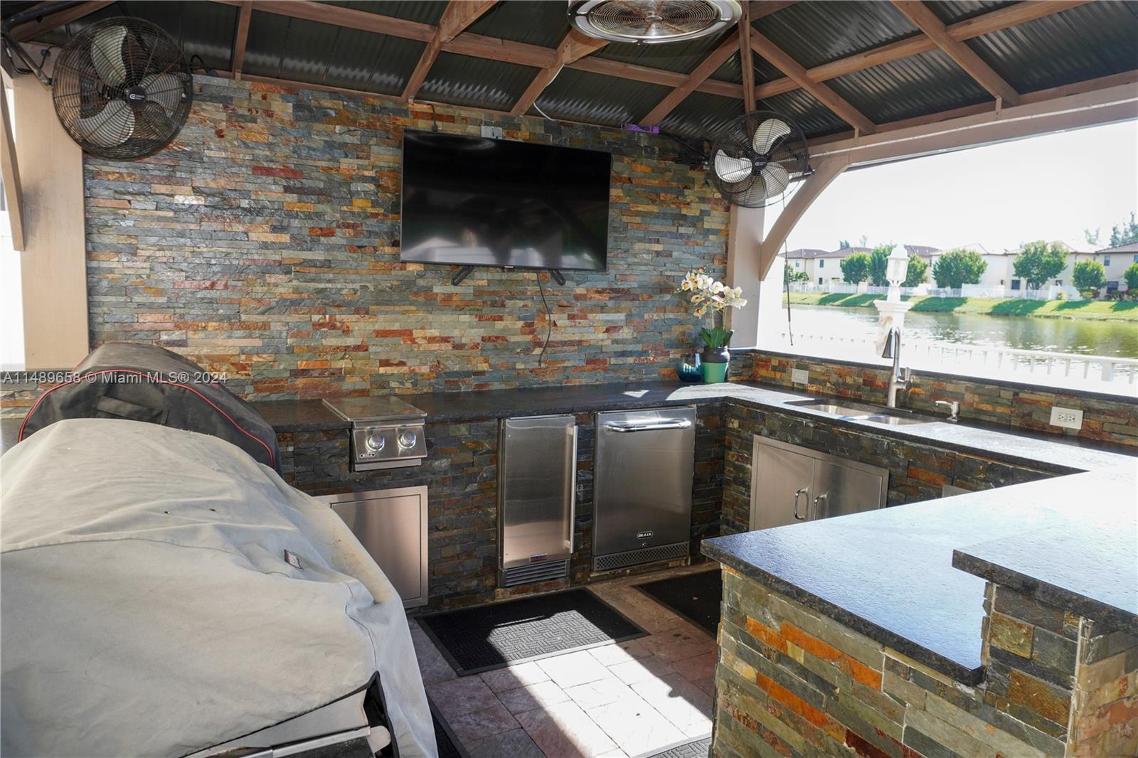 3522 West 88th Street Hialeah, FL 33018 - Photo 43 of 52 a view of a kitchen with a sink and a microwave