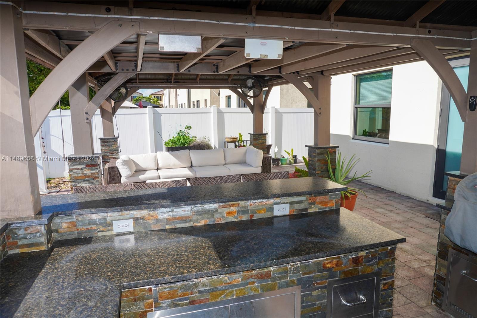 3522 West 88th Street Hialeah, FL 33018 - Photo 47 of 52 a view of a kitchen with kitchen island a counter top space a sink and a window
