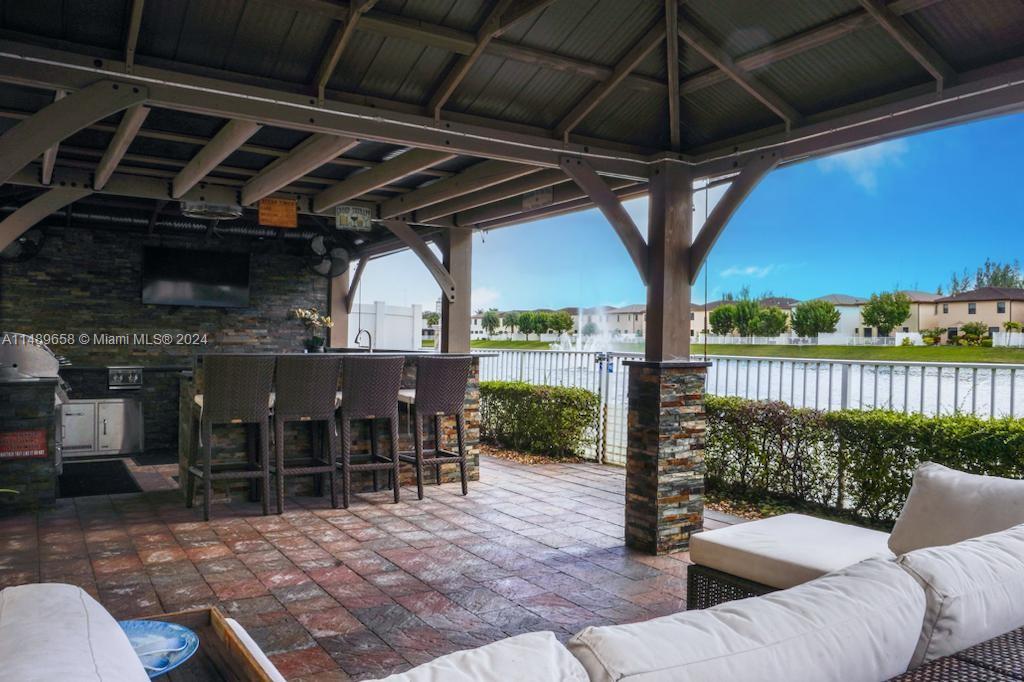 3522 West 88th Street Hialeah, FL 33018 - Photo 52 of 52 a view of a porch with furniture and a yard
