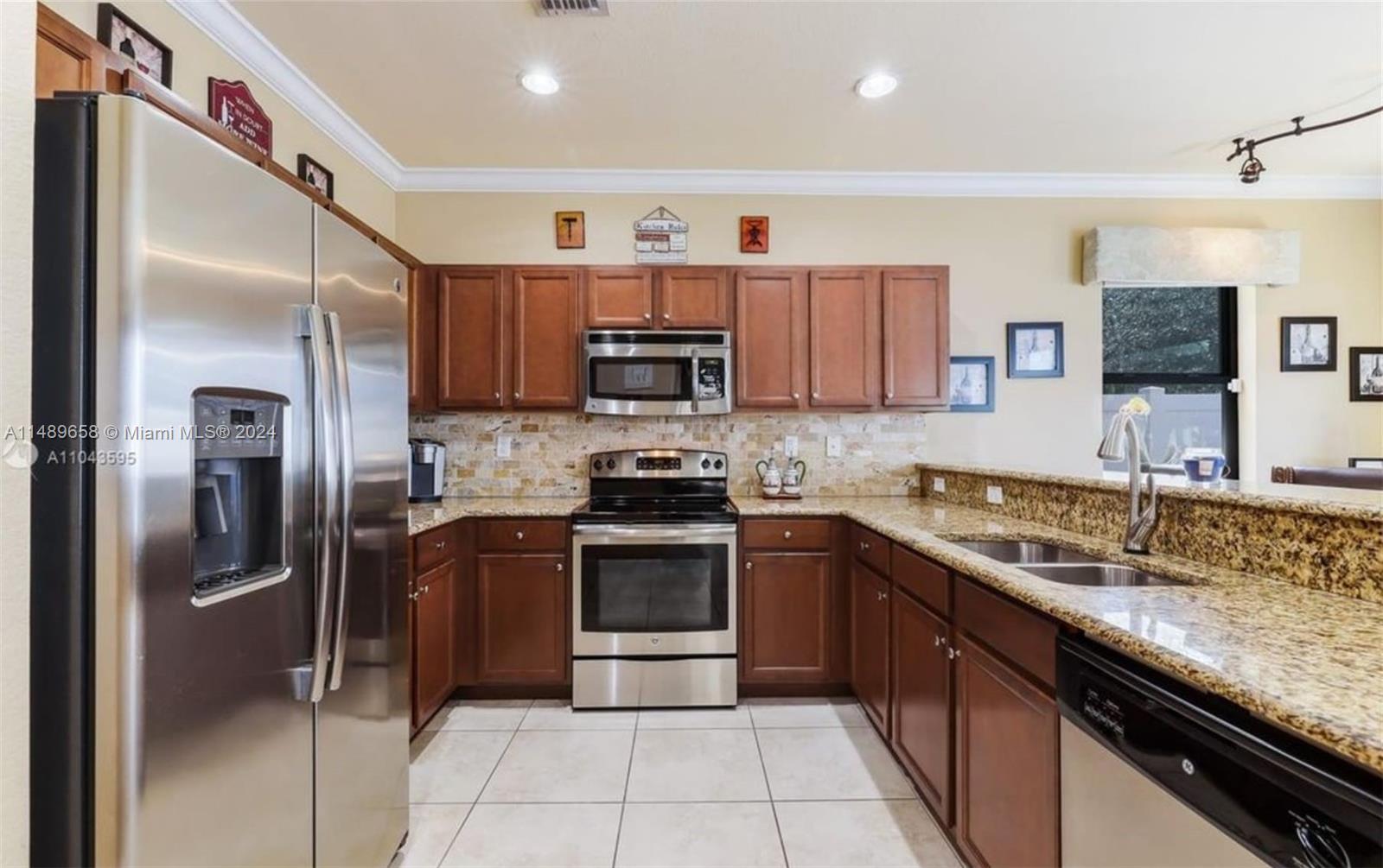 3522 West 88th Street Hialeah, FL 33018 - Photo 7 of 52 a kitchen with stainless steel appliances granite countertop a sink stove and refrigerator