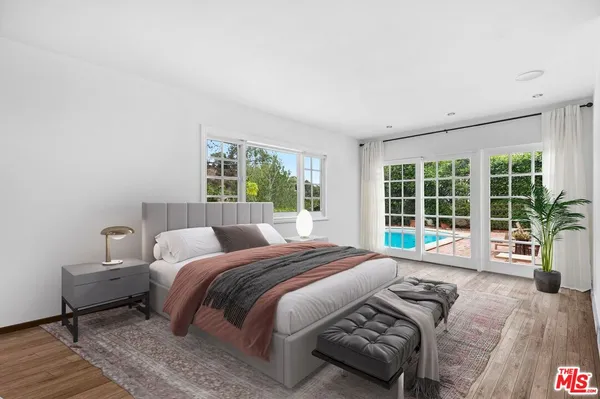 a spacious bedroom with a bed and a large window