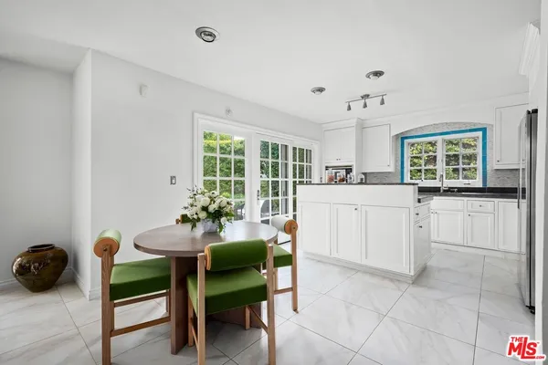 a kitchen with a cabinets and chairs