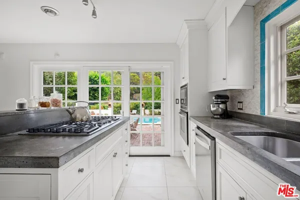 a kitchen with a sink stove and cabinets