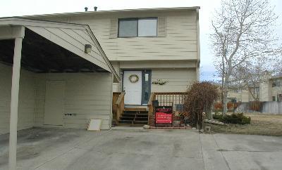 a view of a house with large space and a car parked beside it