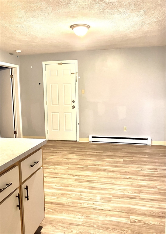 57 Rogers Avenue, Unit 2 Lynn, MA 01902 - Photo 3 of 9 a view of a room with wooden floor and cabinet