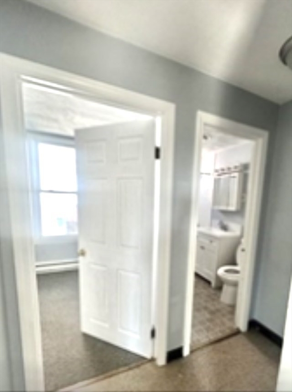 57 Rogers Avenue, Unit 2 Lynn, MA 01902 - Photo 7 of 9 a view of a bathroom with a glass door and a window