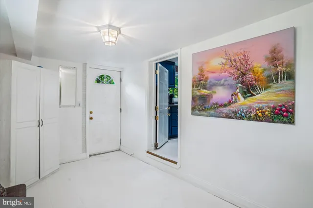 a view of a hallway with a painting on the wall