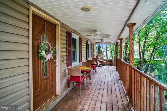 a balcony with furniture and wooden floor