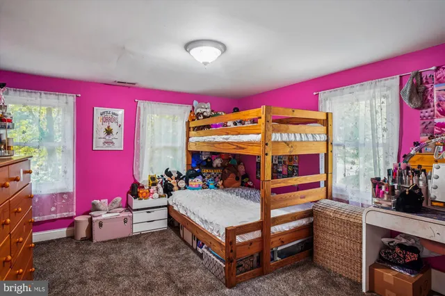 a room with furniture toys and a large window